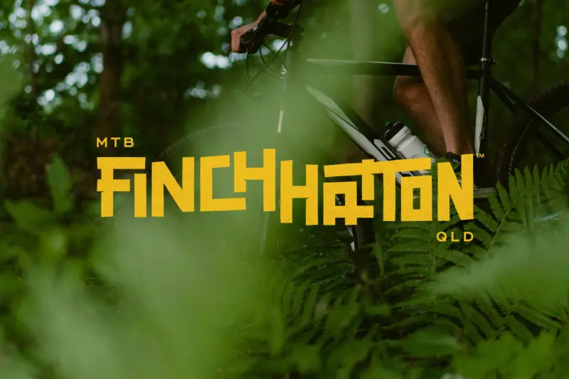 Finch Hatton MTB logo on lush green background